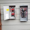 Open residential electrical panels prepared for a panel upgrade in Windsor
