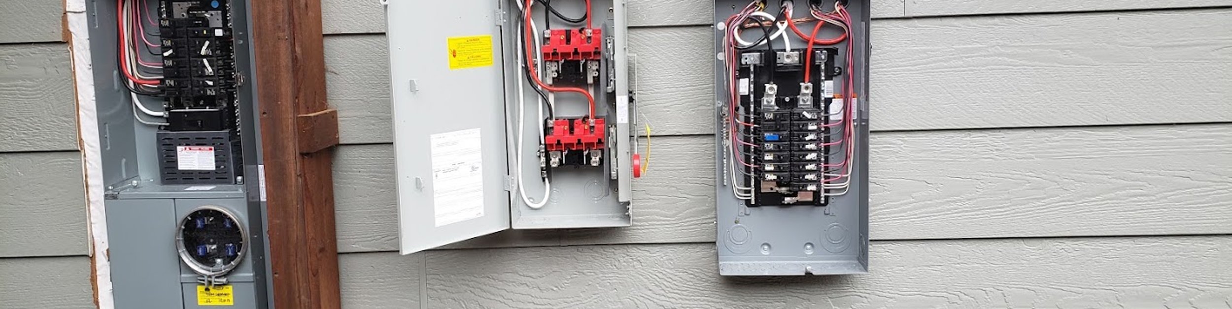 Open residential electrical panels prepared for a panel upgrade in Windsor