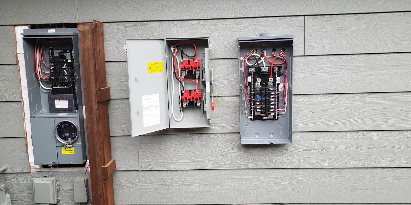 Open residential electrical panels prepared for a panel upgrade in Windsor